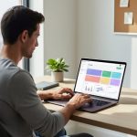 Solo freelance writer at a tidy home office desk, hands on a laptop with an abstract, text-free CRM interface, soft daylight from a side window, with coffee mug, notebook, plant, and blurred corkboard in the background.